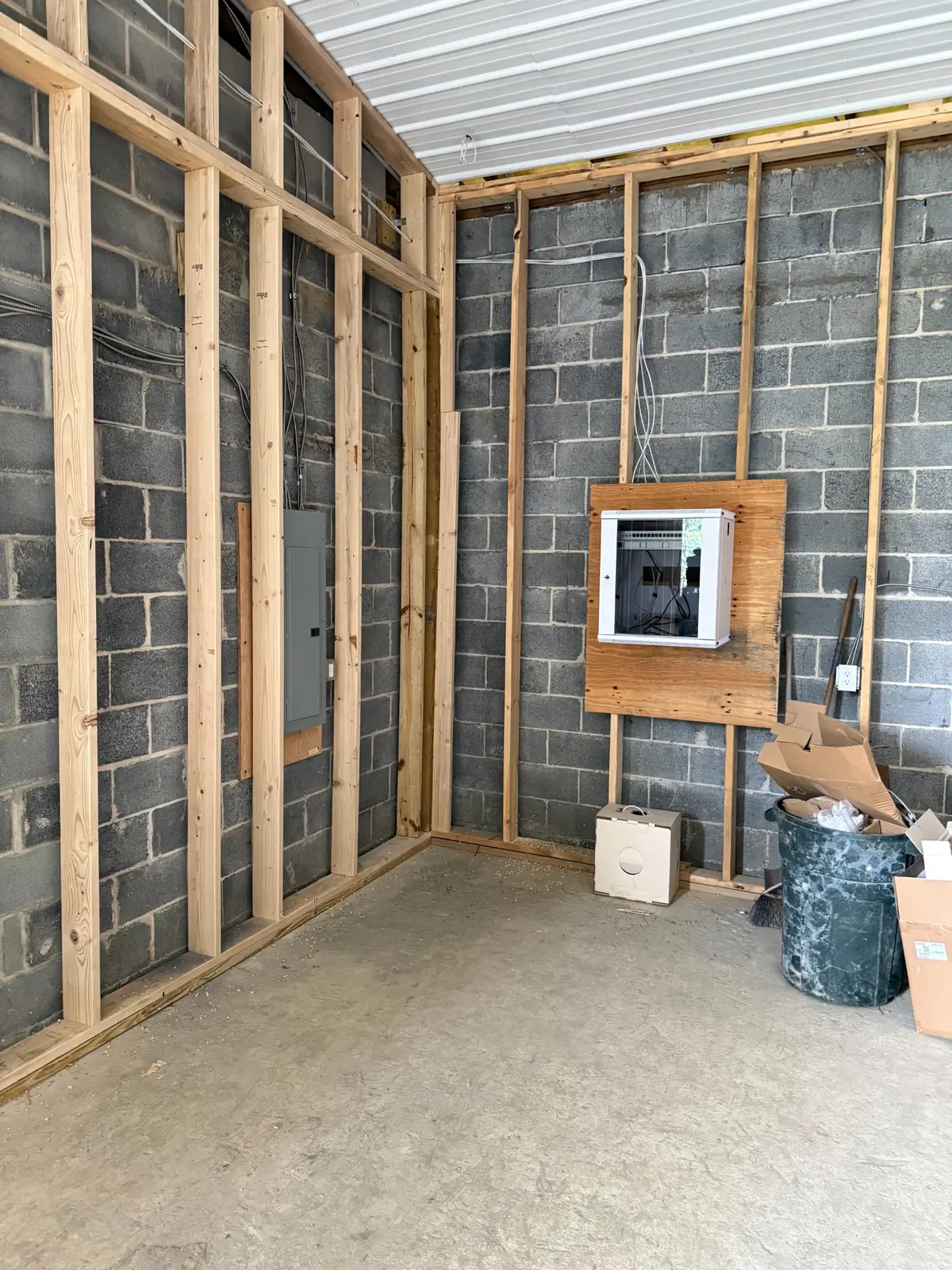 Commercial communications room with wall-mount IDF cabinet during construction